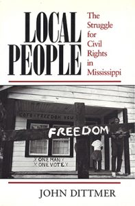 Cover of Dittmer's Local People, with image of Black people going into a building with one man, one vote written on the wall, with a sign reading freedom in the foreground